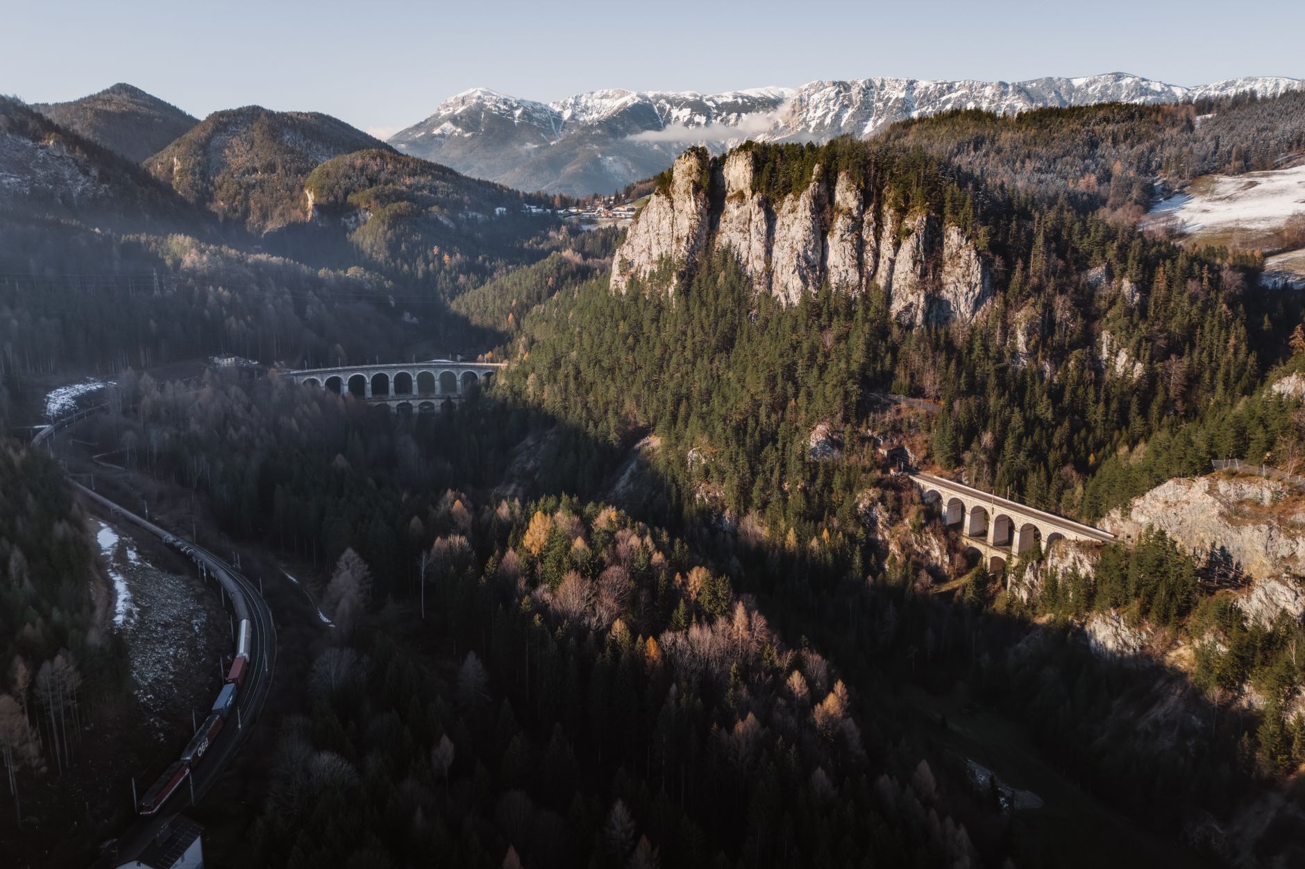 Classic train winding through forested mountains