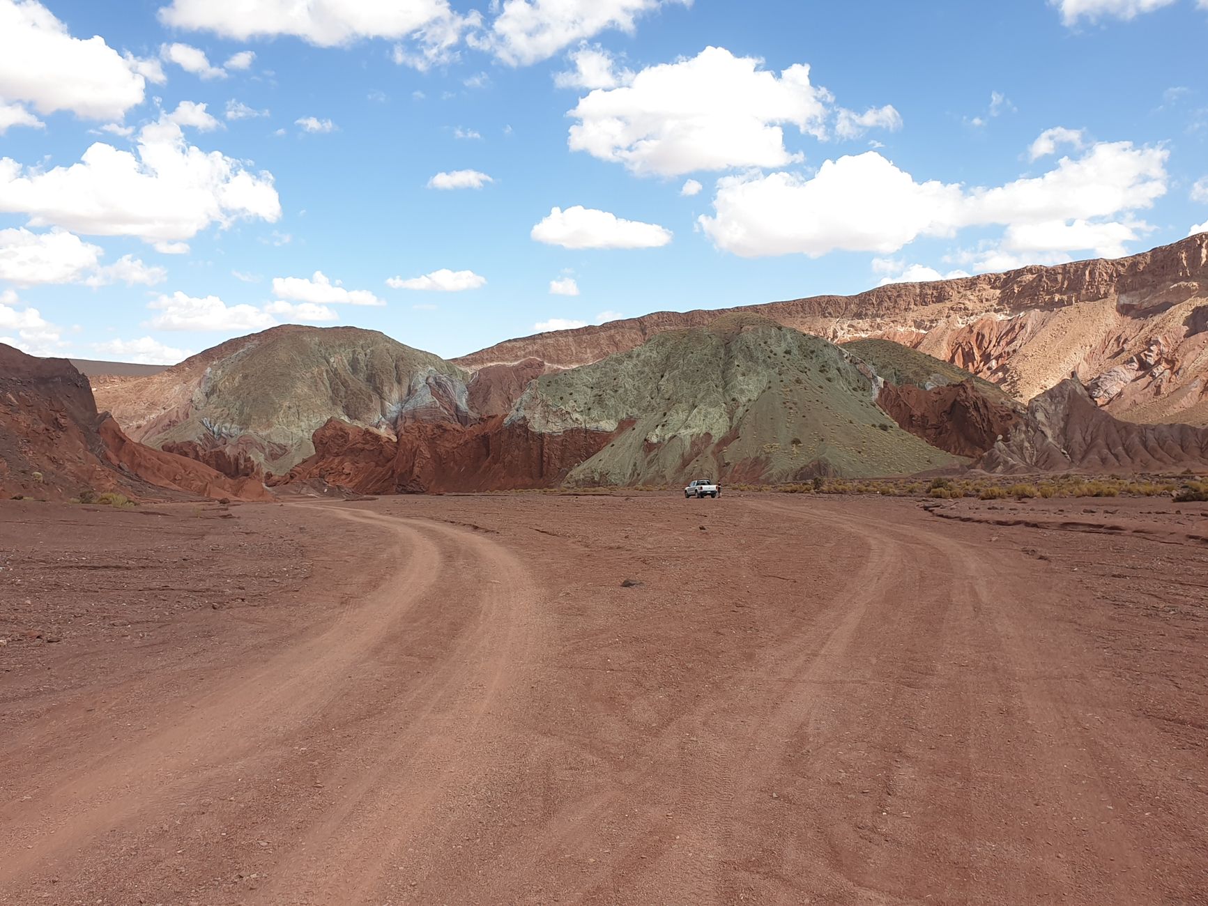 Expansive desert landscape with salt flats and volcanoes